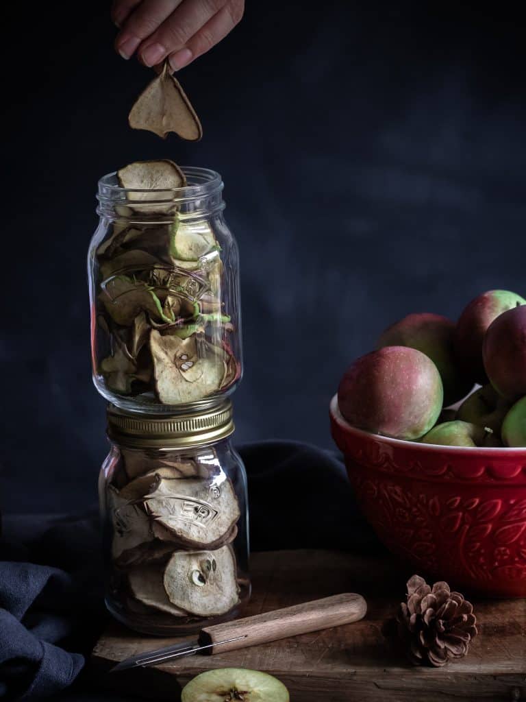 Two jars of dehydrated apple and pears ready to be sealed in airtight jars and preserved for use later. image by Emma Lee TheIrishmansWife.com