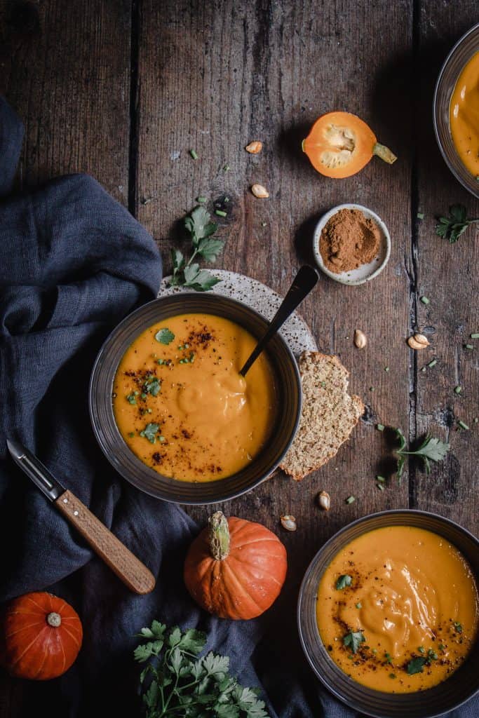 flatlay of three bowls of Butternut pumpkin and chipotle soup
