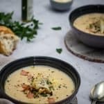 two bowls of cheesy cauliflower and leek soup