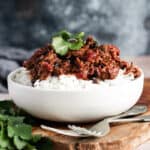 a bowl of slow-cooked Mexican beef cheeks on a bed of rice in a bowl
