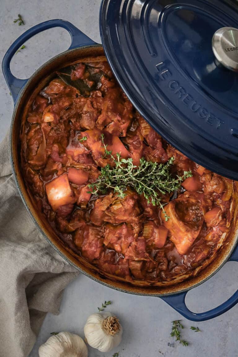 a big blue oval pot of just cooked beef stew.