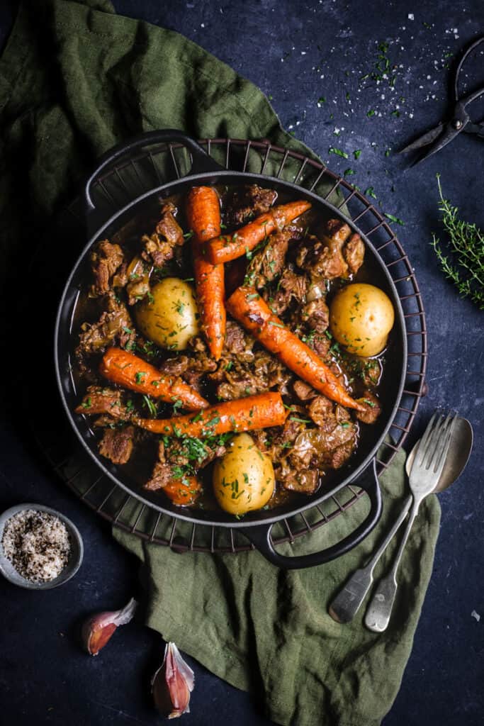 a cast iron dutch oven full of slow cooked Irish lamb stew.