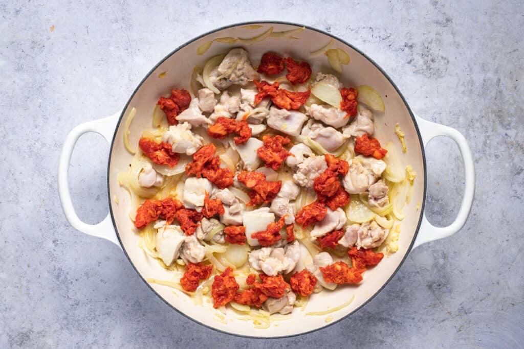 chicken, chorizo, onion and garlic sauteing in a pan
