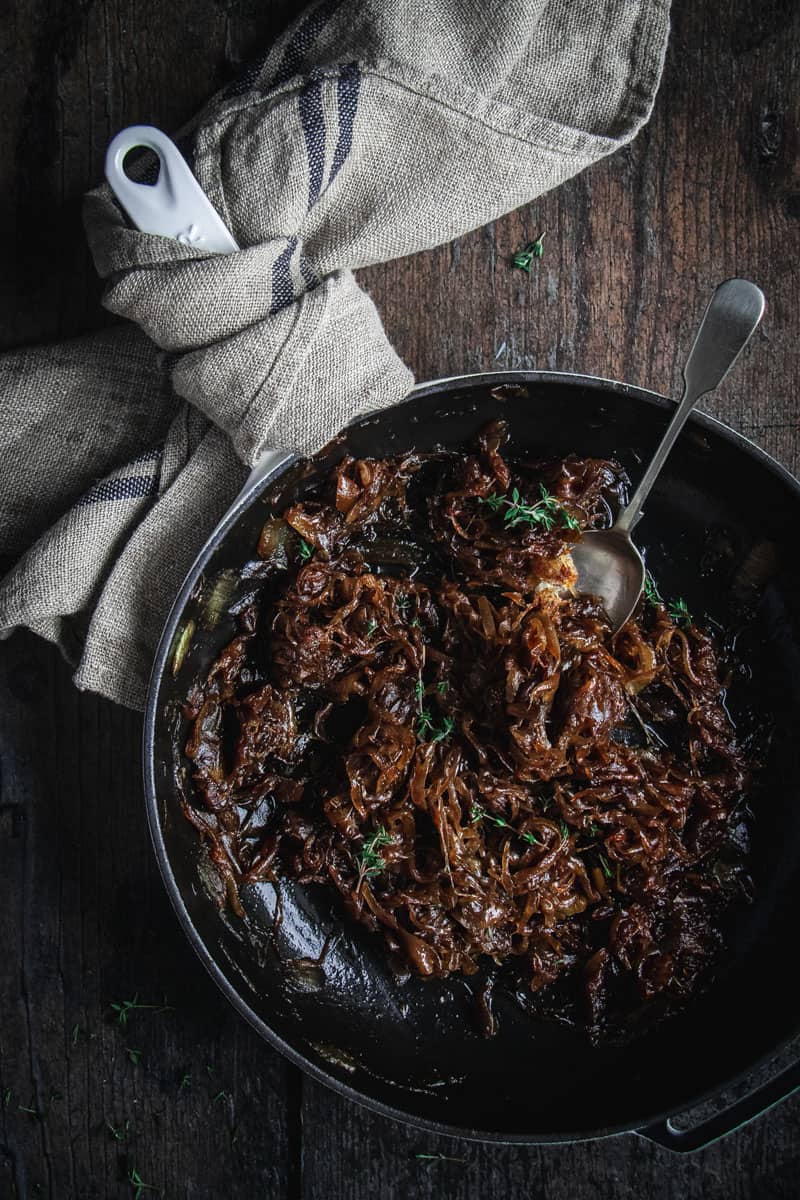 A cast iron pan full of slow cooked caramelized onion jam.