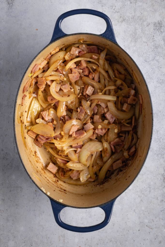 Saute onion, garlic and bacon in the pot.