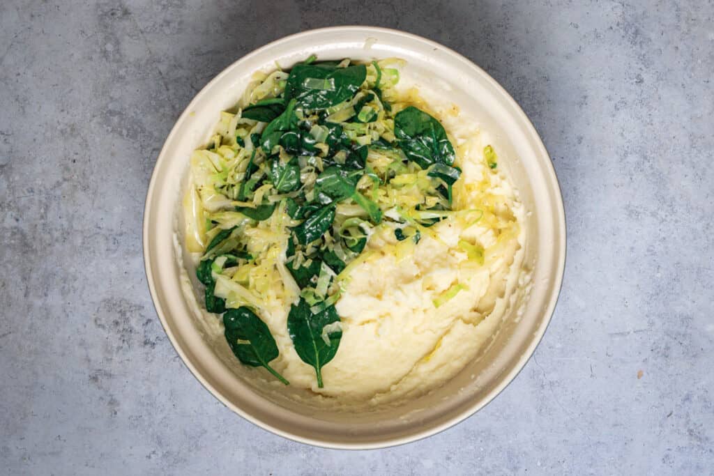 Gently cooked greens are added to the creamy mashed potatoes.