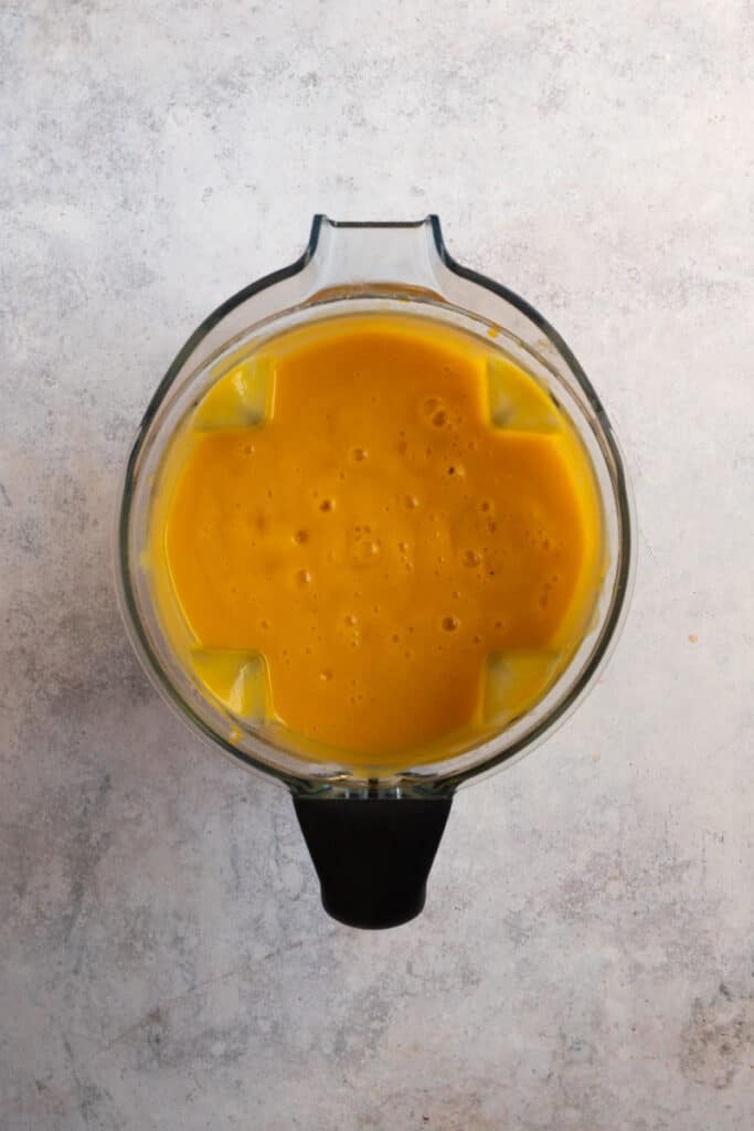 Blend the slow-cooked pumpkin soup until smooth.