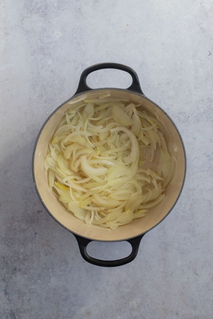 Sauteed onions on a pot.