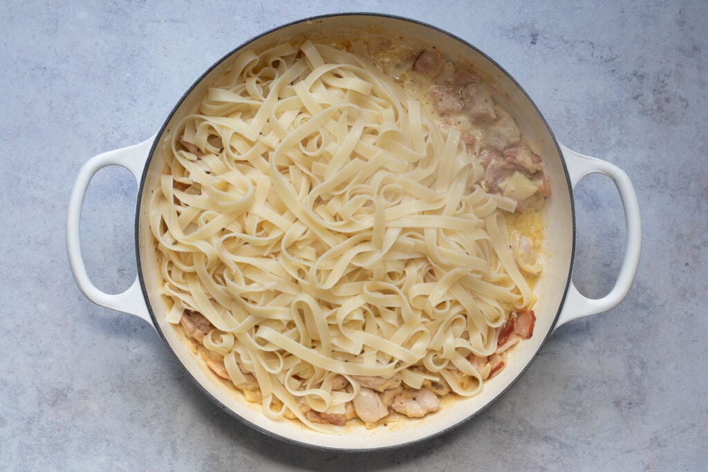 Add the fettuccine to the pan. 