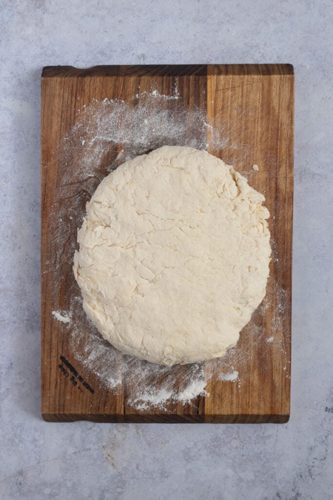 The dough is turned out onto a floured board and formed into a disc-shaped dough.