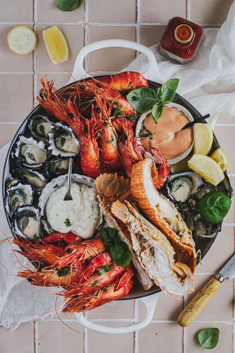 A seafood platter on a tiled bench full of Fresh Australian seafood.